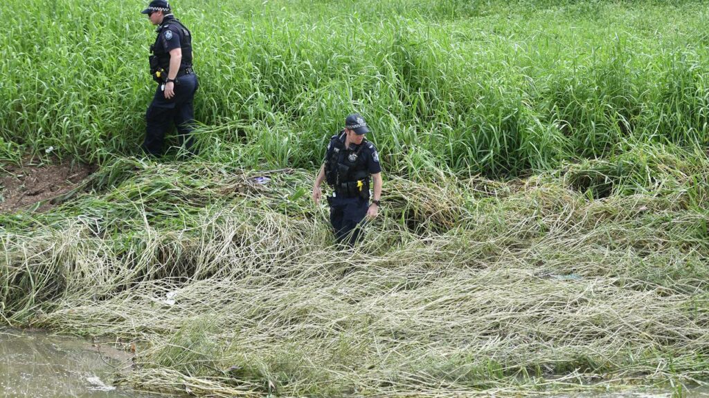 Two Palm Island men likely died within minutes of being forced under floodwaters in Townsville.