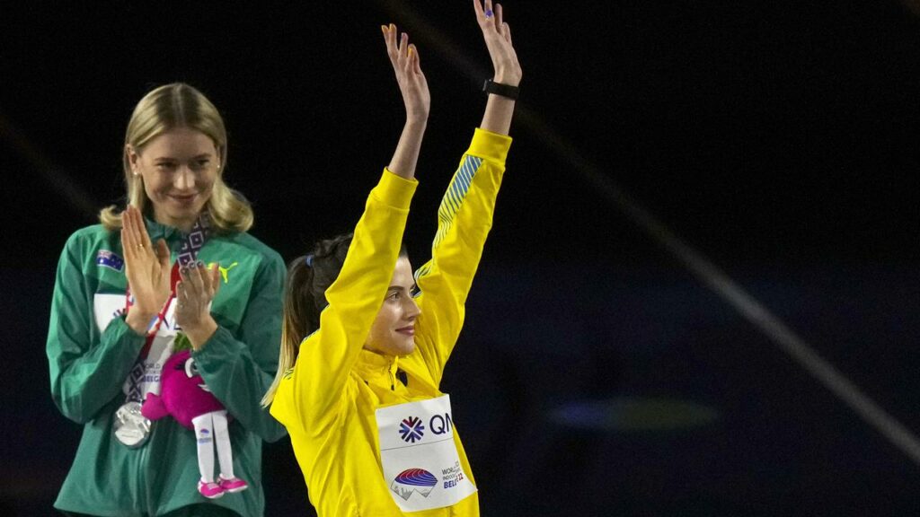 Eleanor Patterson applauds Yaroslava Mahuchikh for her gold medal at the world indoors in March.