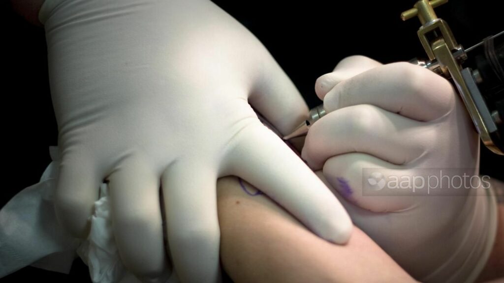 Tattooists, motor dealers, and removalists are in the sights of Queensland’s fair trade regulator. (Robert McGrath/AAP PHOTOS)