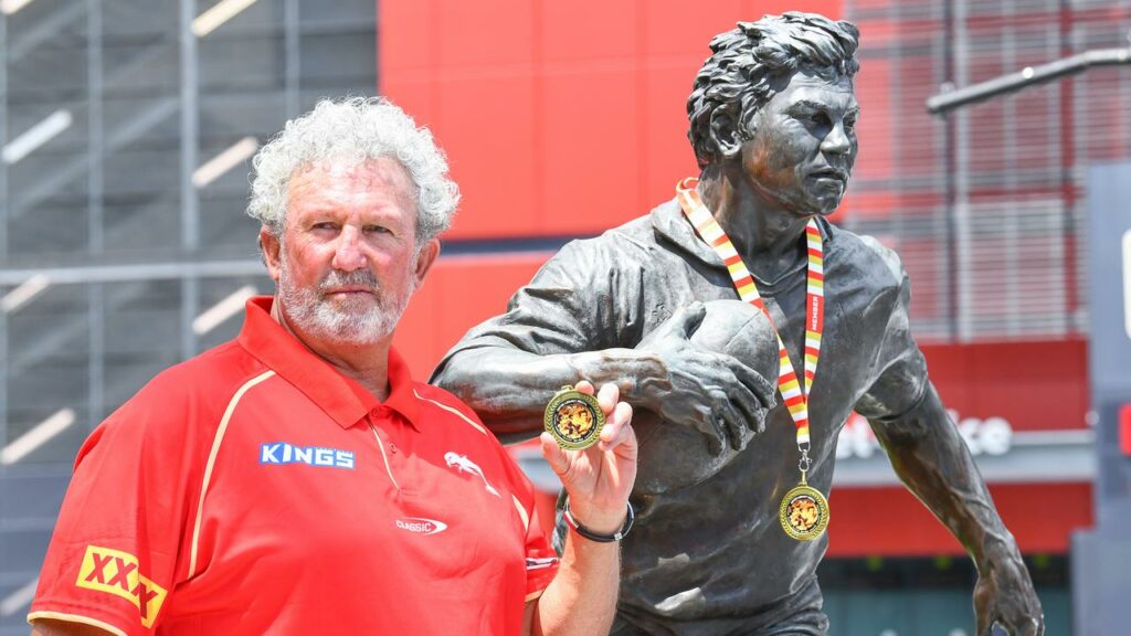 Brad Beetson, son of Arthur Beetson, with his father’s statue and the inaugural Artie Legacy Medal.
