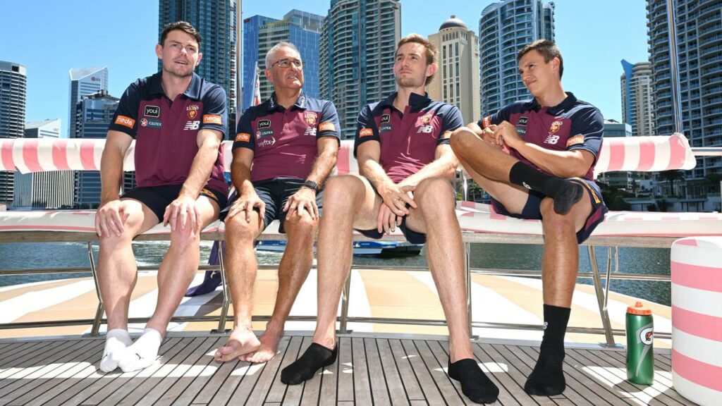 Chris Fagan (2-l) is flanked by Lachie Neale (l) and Harris Andrews (r), and Hugh McCluggage.