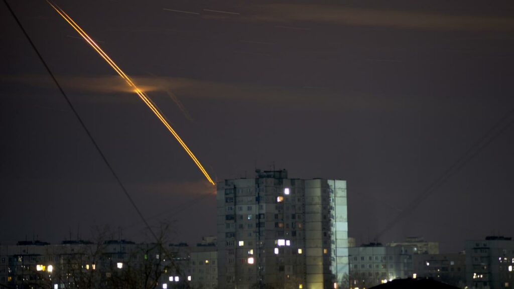 Russian rockets launched against Ukraine streak across the sky at dawn in Kharkiv.
