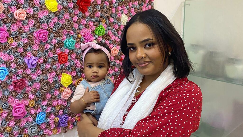 Amal Osman, with eight-month-old daughter Elan, is desperate to leave war-torn Sudan for Australia.