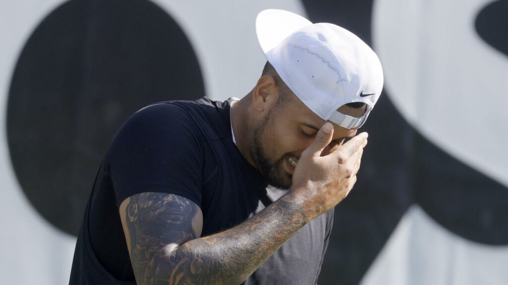 Nick Kyrgios grimaces as he struggles with knee pain during his comeback match defeat to Yibing Wu.