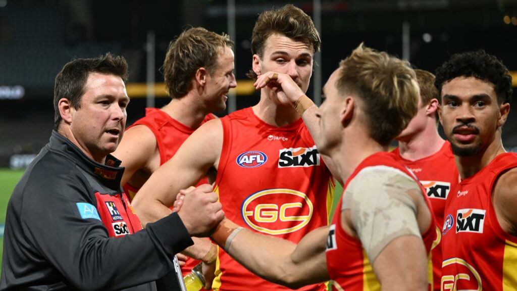 Port Adelaide are expecting a fired-up Gold Coast to rally around under-fire coach Stuart Dew (l).
