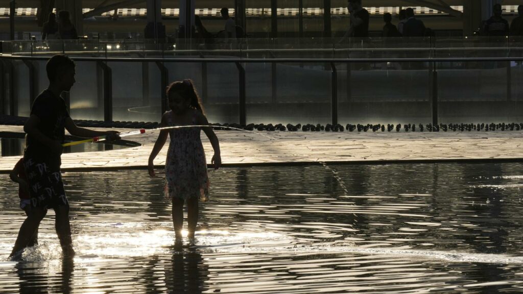 Children have played in a fountain in Milan amid an intense heat wave in Italy.