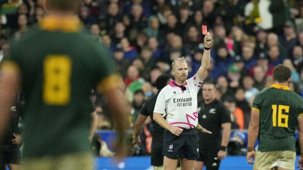 Referee Wayne Barnes shows a red card to New Zealand captain Sam Cane in the Rugby World Cup final.