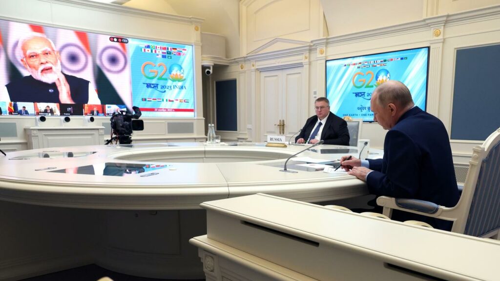 Russian President Vladimir Putin listened to Indian Prime Minister Narendra Modi at a G20 meeting.