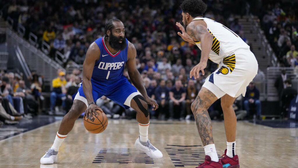 Los Angeles Clippers guard James Harden (left) eyeballs Indiana Pacers forward Obi Toppin.