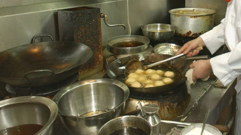A Chinese takeaway owner delivered a flying kick to a gunman’s chest when he went into the kitchen.