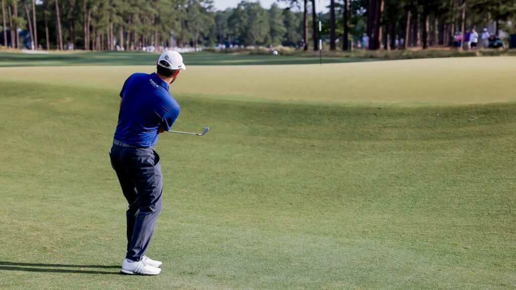 Patrick Cantlay chips onto the 10th green at the US Open, in which he leads the early starters.