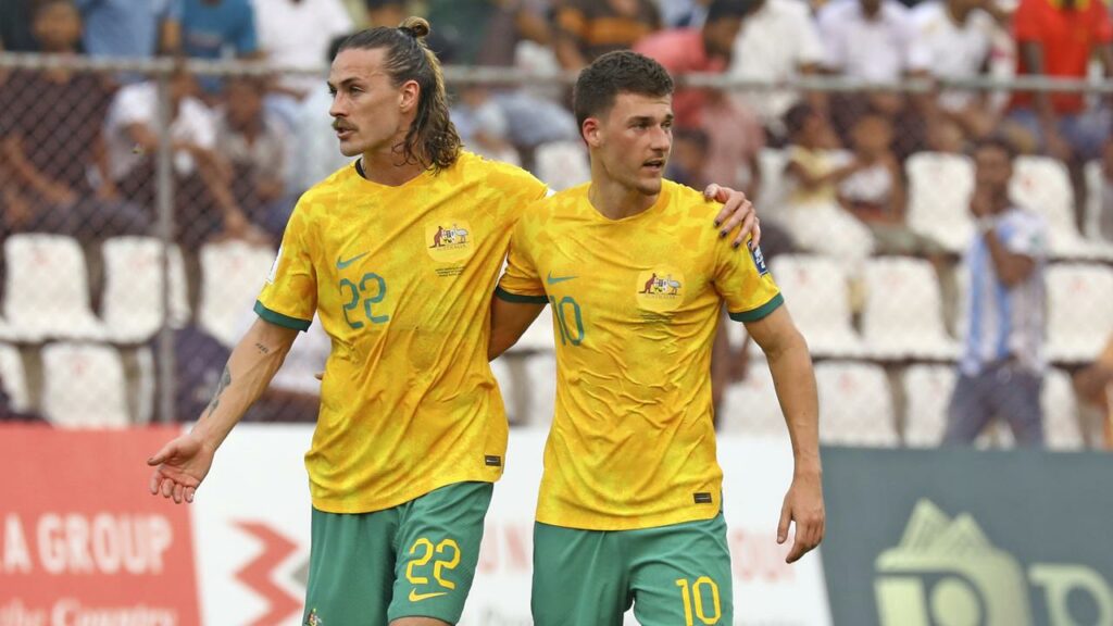 A deflected Ajdin Hrustic (R) strike has helped the Socceroos on their way to victory in Bangladesh.
