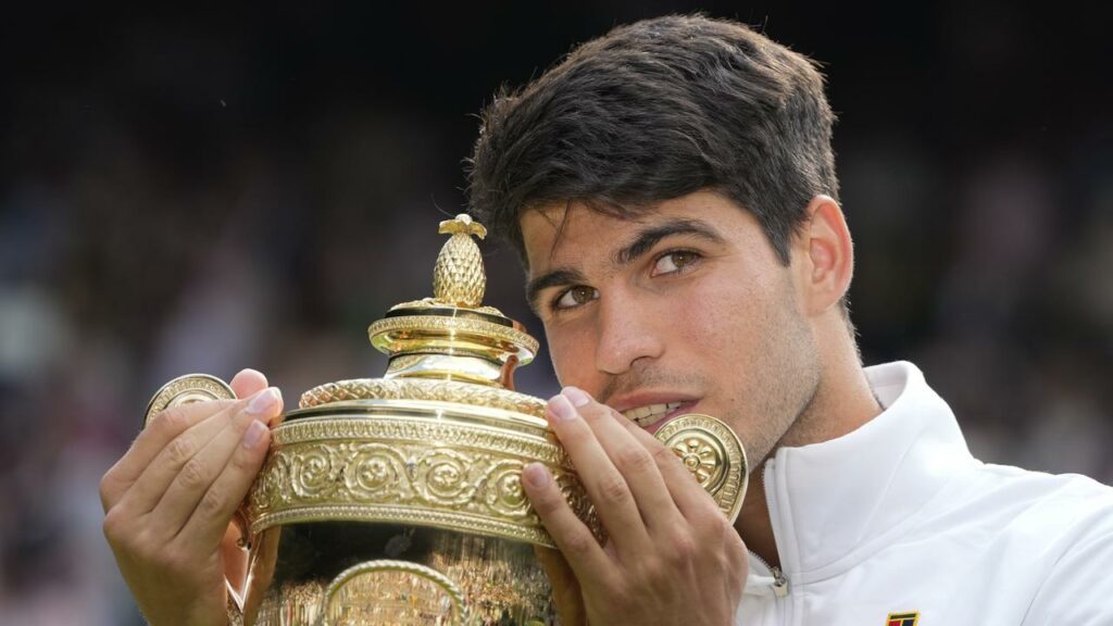 Carlos Alcaraz clutches the Wimbledon men’s singles trophy again after a fabulous win.