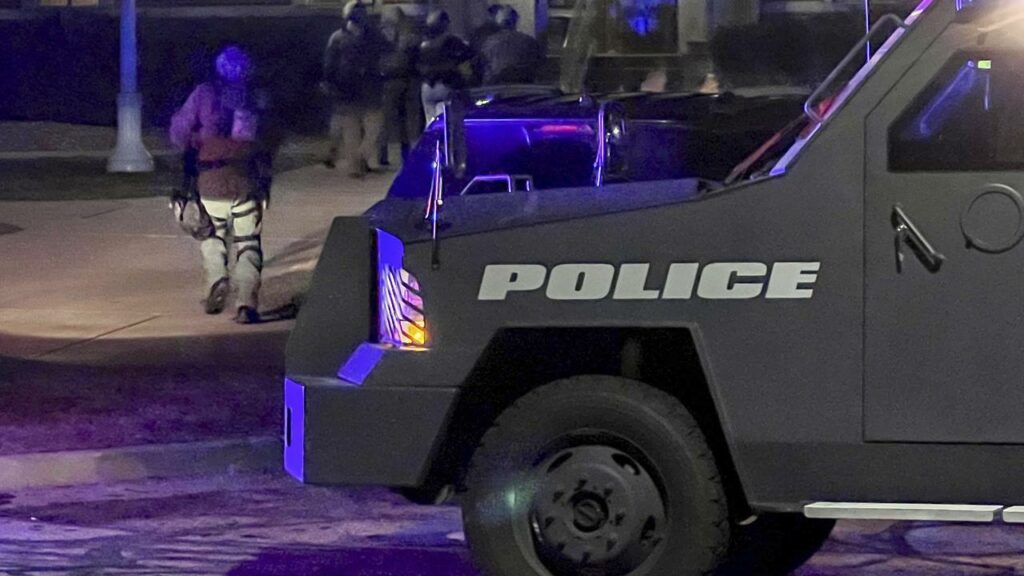 Authorities are hunting a gunman who shot two people dead and injured 19 in Detroit.
