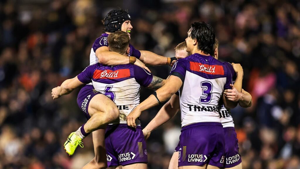 Melbourne players celebrate a win over Penrith that has them poised to claim the minor premiership.