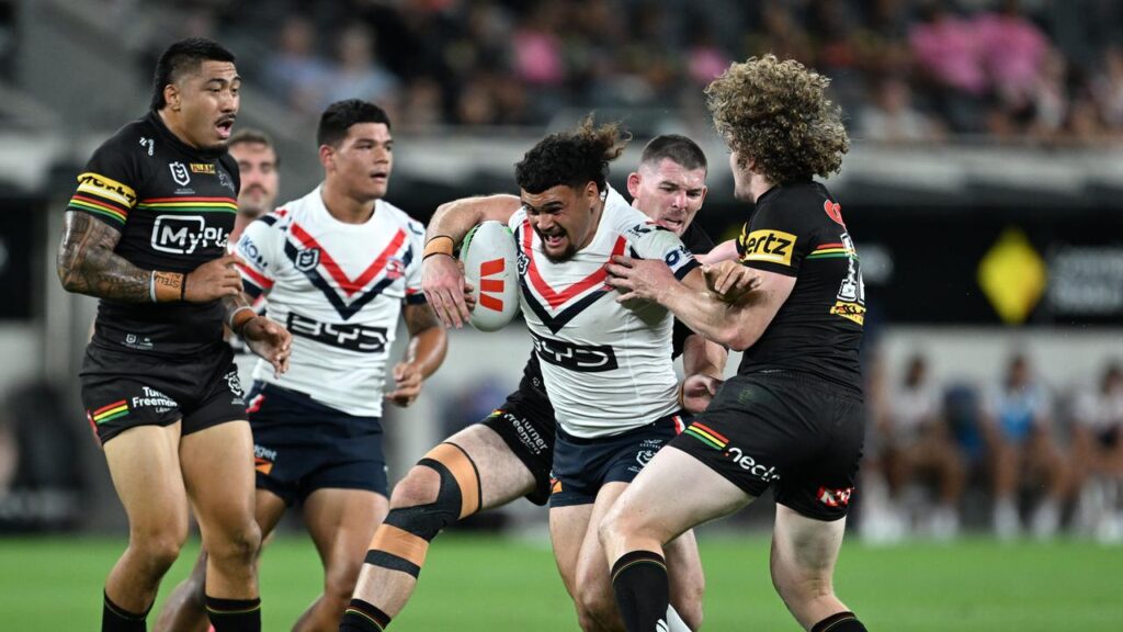 Taylor Losalu runs hard at Penrith in only his second NRL match for the Sydney Roosters.
