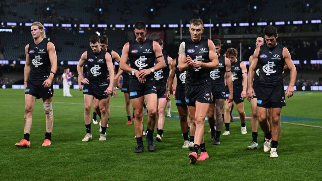 Patrick Cripps leads his disappointed Carlton team off the field after their latest loss.