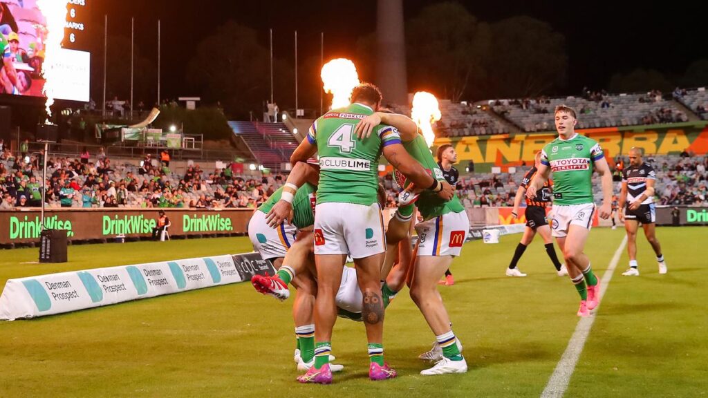 Canberra celebrate one of Hudson Young’s two tries in their last-gasp NRL win over Cronulla.