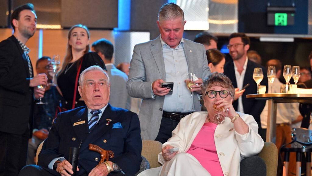 The atmosphere is muted as supporters watch early counting results at the Liberal function.