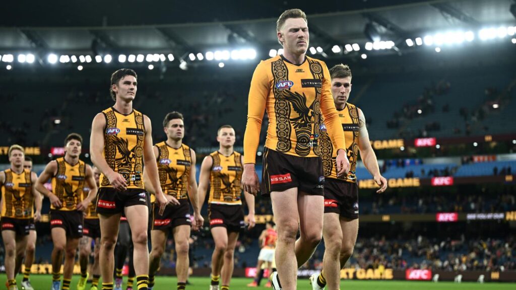 Captain James Sicily leads Hawthorn off the MCG after their loss to Brisbane.