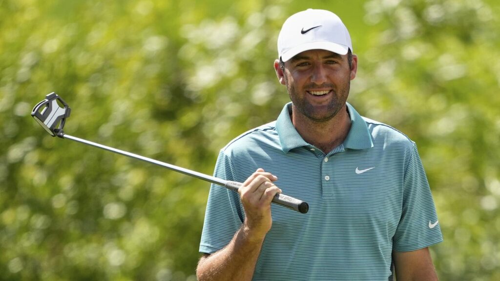 Scottie Scheffler smiles on the seventh at the PGA as he moved into the joint-lead at Quail Hollow.