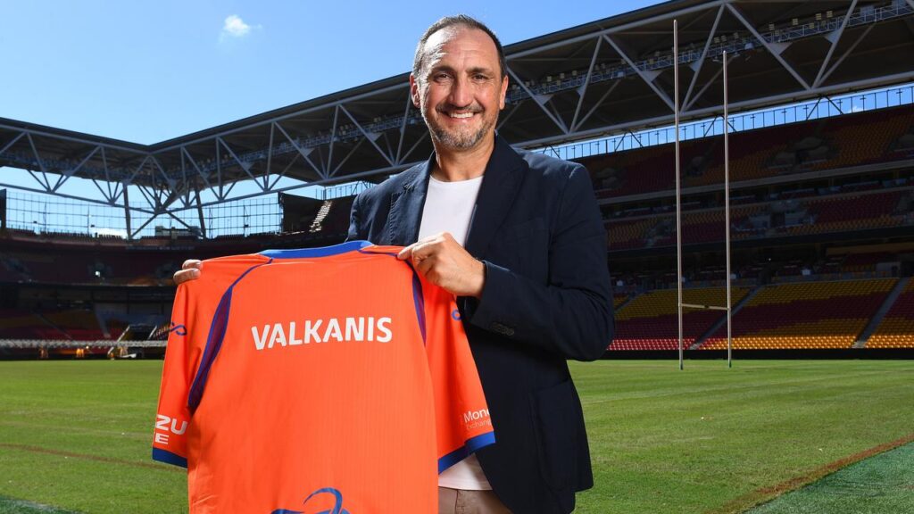 Michael Valkanis shows off his new true colours after being appointed Brisbane Roar coach.