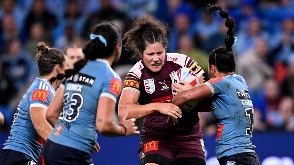 Kennedy Cherrington (R) piles in to tackle Chelsea Lenarduzzi amid their dramatic Origin clash.
