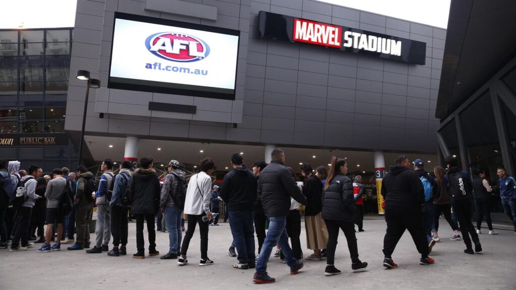 A teenage boy has been given a caution after trying to take a knife and fake gun into an AFL game.
