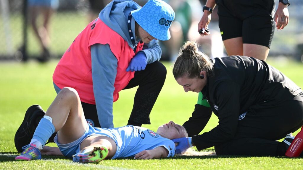 Melbourne City striker Holly McNamara is assisted after a head clash during their ALW semi-final.