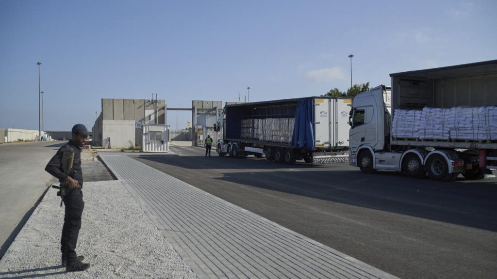 Trucks carrying humanitarian aid wait to enter the border crossing between Israel and Gaza.