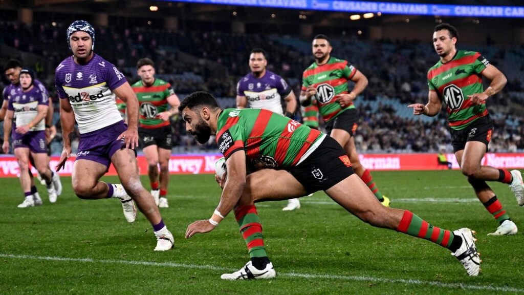 South Sydney’s Alex Johnston scores one of his four tries in their golden-point loss to Melbourne.
