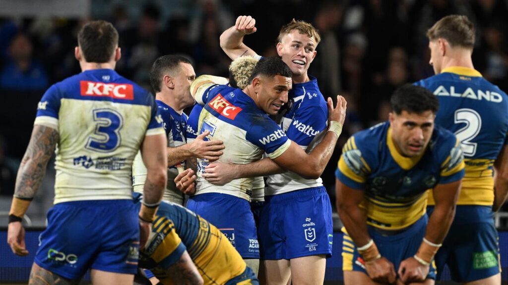 Young Lachlan Galvin is embraced by his Bulldogs teammates after scoring a try against the Eels.
