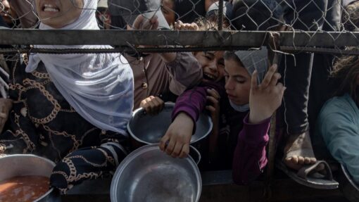 Palestinians gather to receive aid