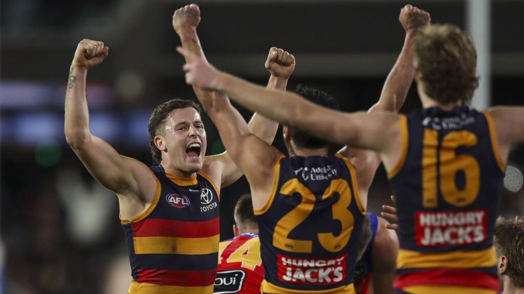 Adelaide’s Jake Soligo (left) and teammates salute after their thrilling win over Brisbane.