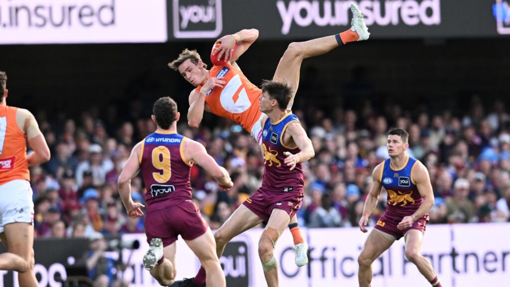 Aaron Cadman soars above Brisbane’s Eric Hipwood to take one of 13 marks for the Giants.
