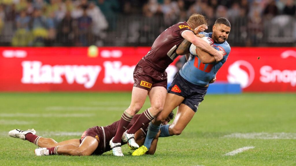 Tom Dearden, here tackling Latrell Mitchell, proved impressive as he took the Maroons’ No.7 shirt.