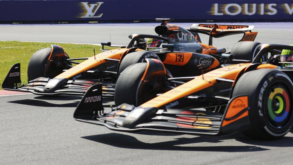 The McLarens of Oscar Piastri (L) and Lando Norris duelling for the lead before their collision.