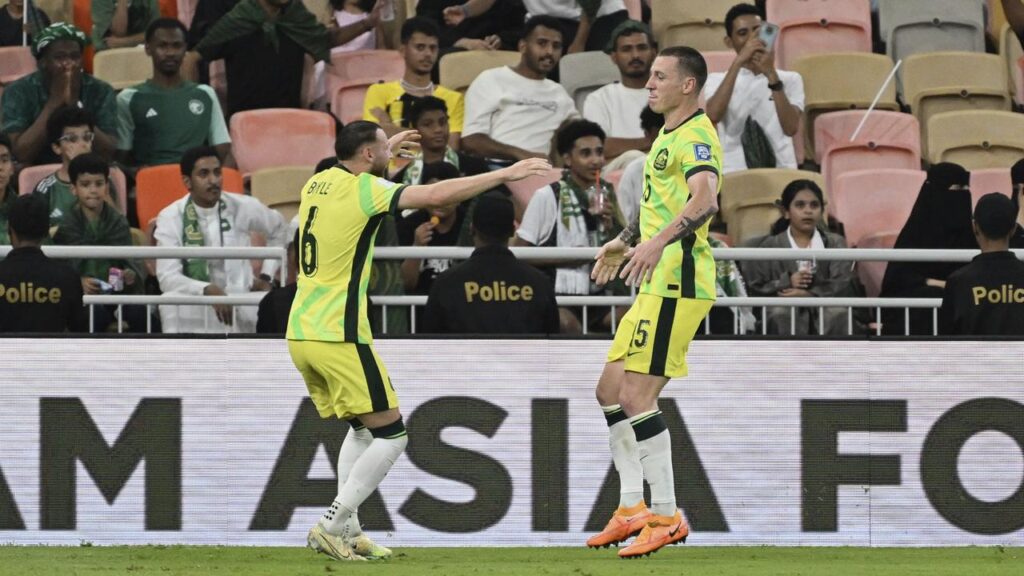 Martin Boyle (6) congratulates Mitch Duke after he put Australia 2-1 up against Saudi Arabia.