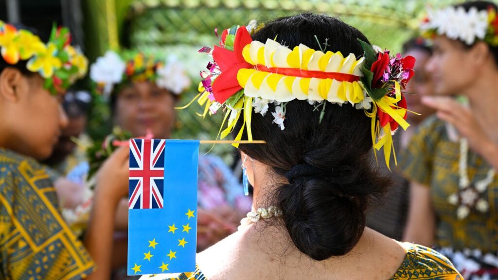 A performer wears the flag of Tuvalu at a signing ceremony for the Australia-Tuvalu Falepili Union.