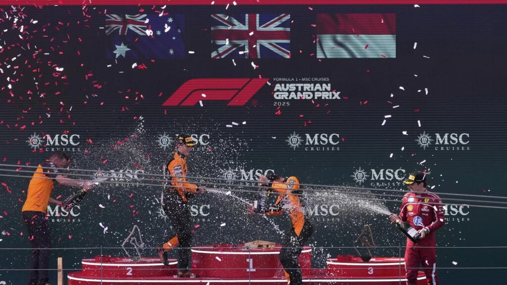 Podium joy for Oscar Piastri (L), McLaren teammate and winner Lando Norris (C) and Charles Leclerc.