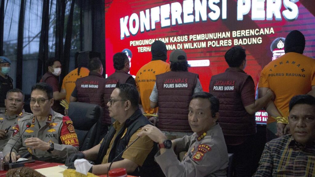 Indonesian police presented three Australian suspects handcuffed and wearing orange prison uniforms.