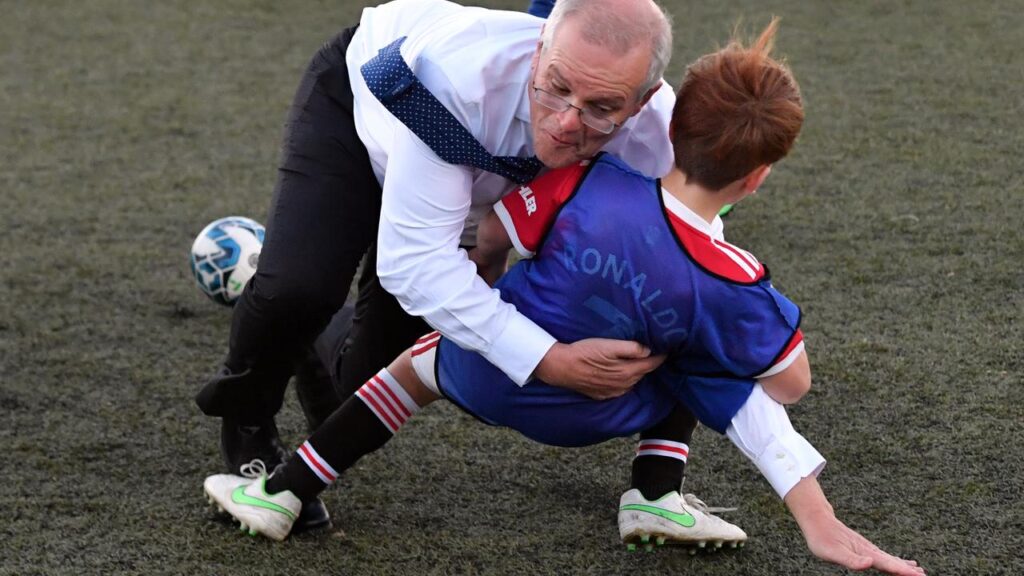 Scott Morrison tackled his political career head on, just like his crash with this kid on the pitch.
