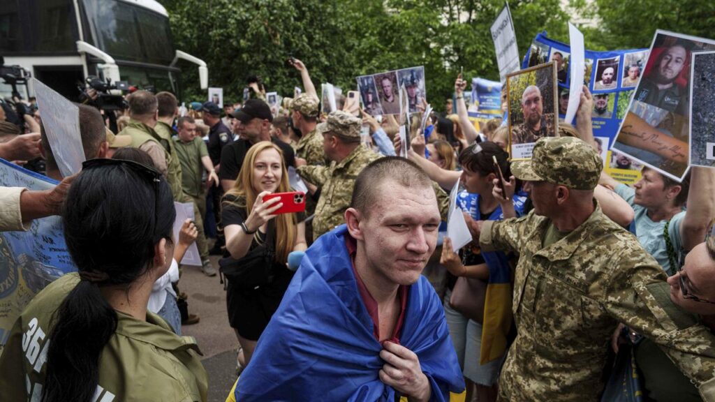 Some women held up pictures of missing relatives as released Ukrainian soldiers returned home.