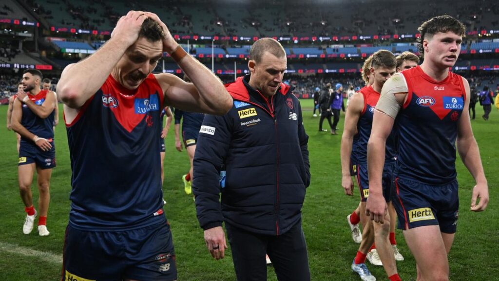 Coach Simon Goodwin (centre) wants to relieve some of the pressure on the off-target Demons.