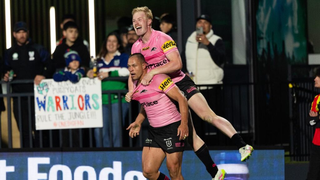 Scott Sorenson (bottom) celebrates one of his two tries as Penrith upset the Warriors in Auckland.