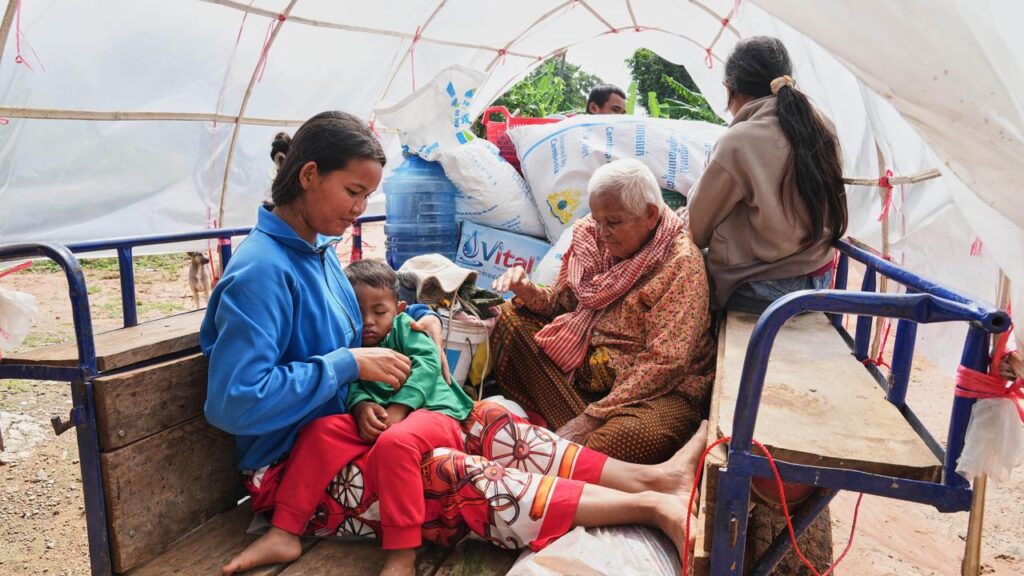 A Cambodian family returns home from a temporary shelter following a Thai-Cambodian ceasefire deal.