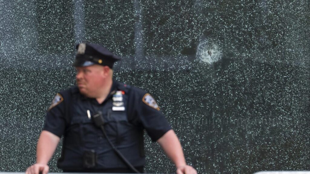 Authorities say a gunman immediately opened fire on a police officer in a NYC building’s lobby.