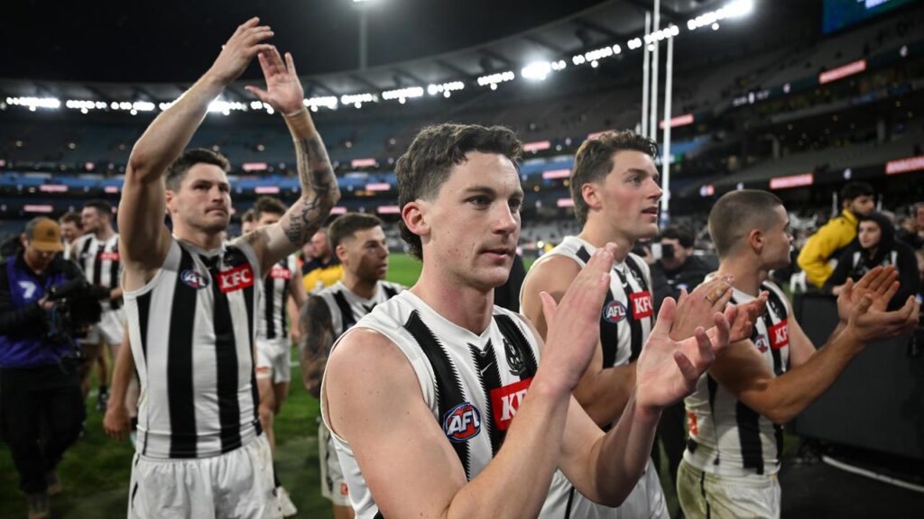 Debutant Roan Steele (centre) celebrates Collingwood’s crushing win over arch-rivals Carlton.