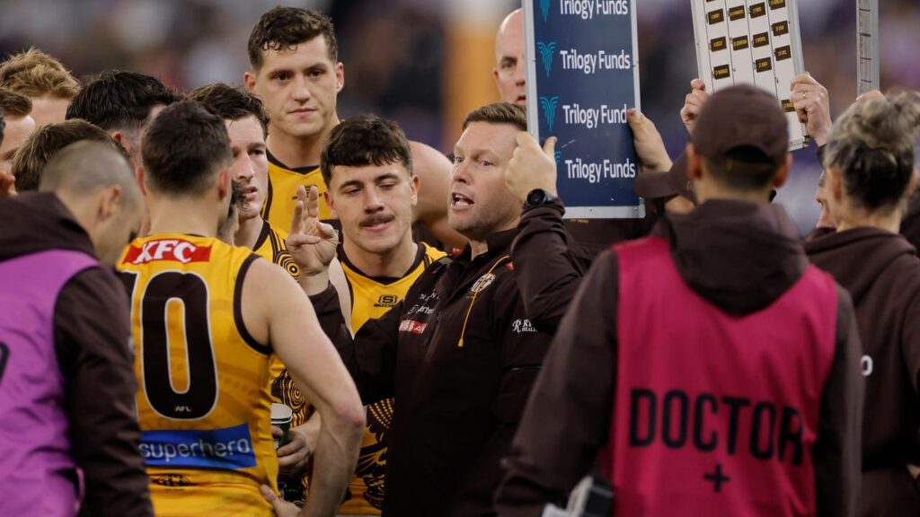 Hawks’ coach Sam Mitchell talks to his team amid a defeat that felt like a “punch to the stomach.”