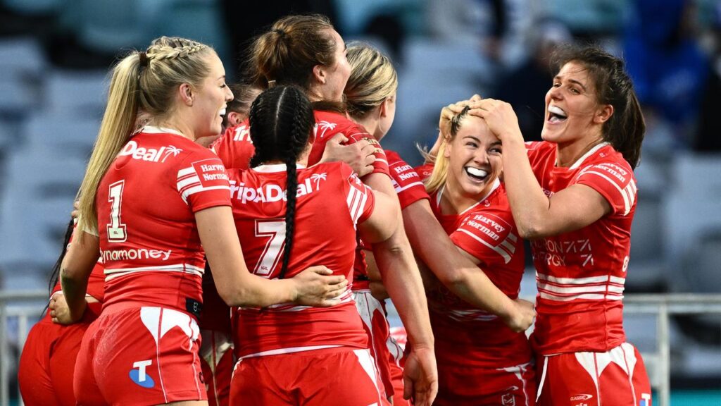 Dragons teammates rush to congratulate Kasey Reh (second right) after she scored the match-winner.